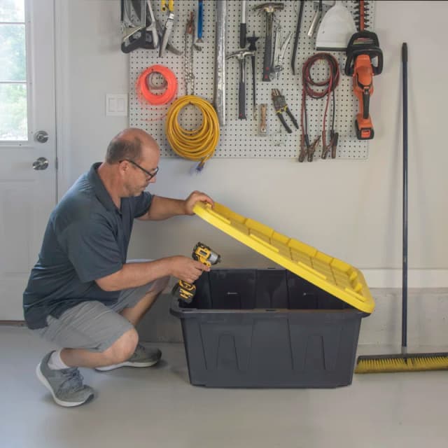 Person packing a storage bin