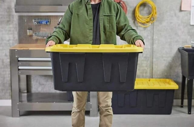 Person holding a storage bin